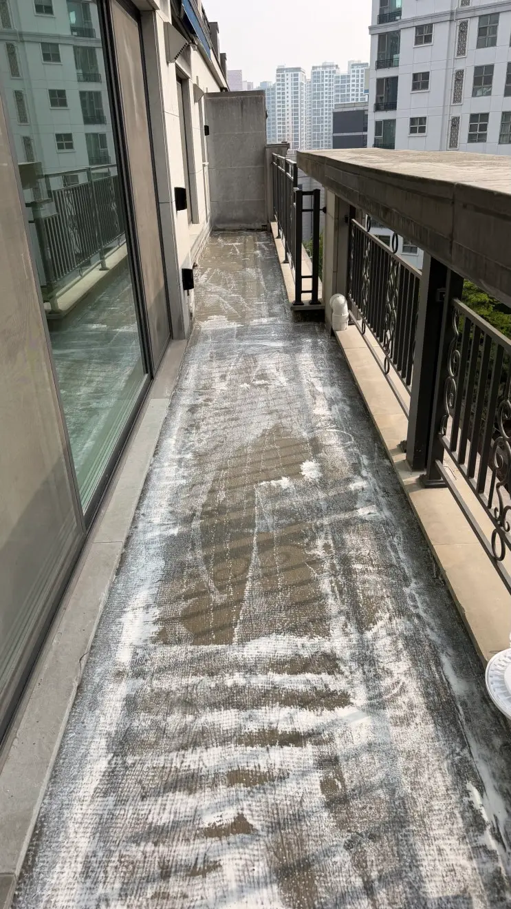 타일 철거 뒤 드러난 반포동 테라스 바닥을 청소하는 모습